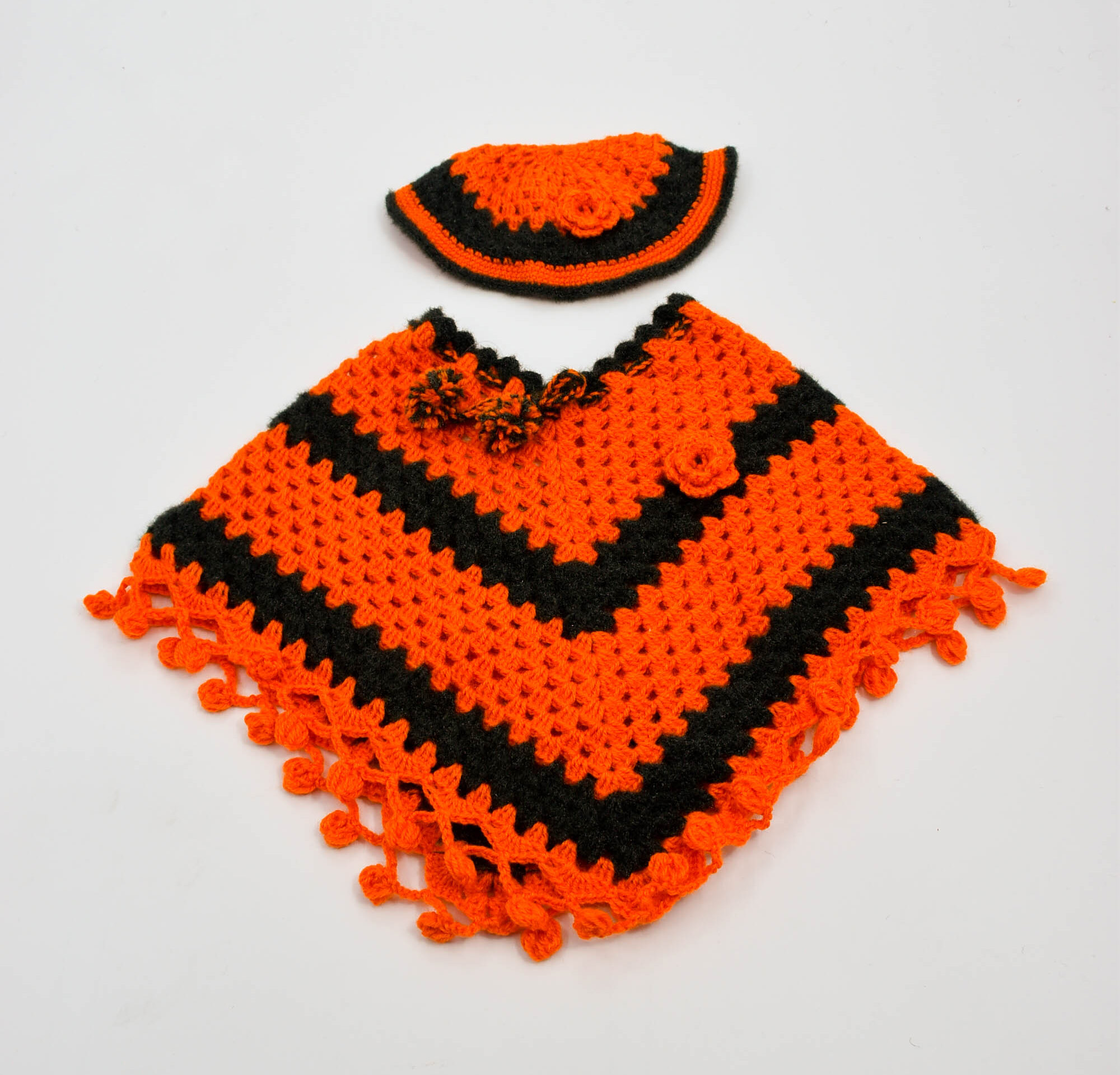 Handknitted Woolen Kids Poncho and Cap Set, Orange and Black (6 Months - 1 Year) Handknitted Woolen Kids Poncho and Cap Set, Orange and Black (6 Months - 1 Year)