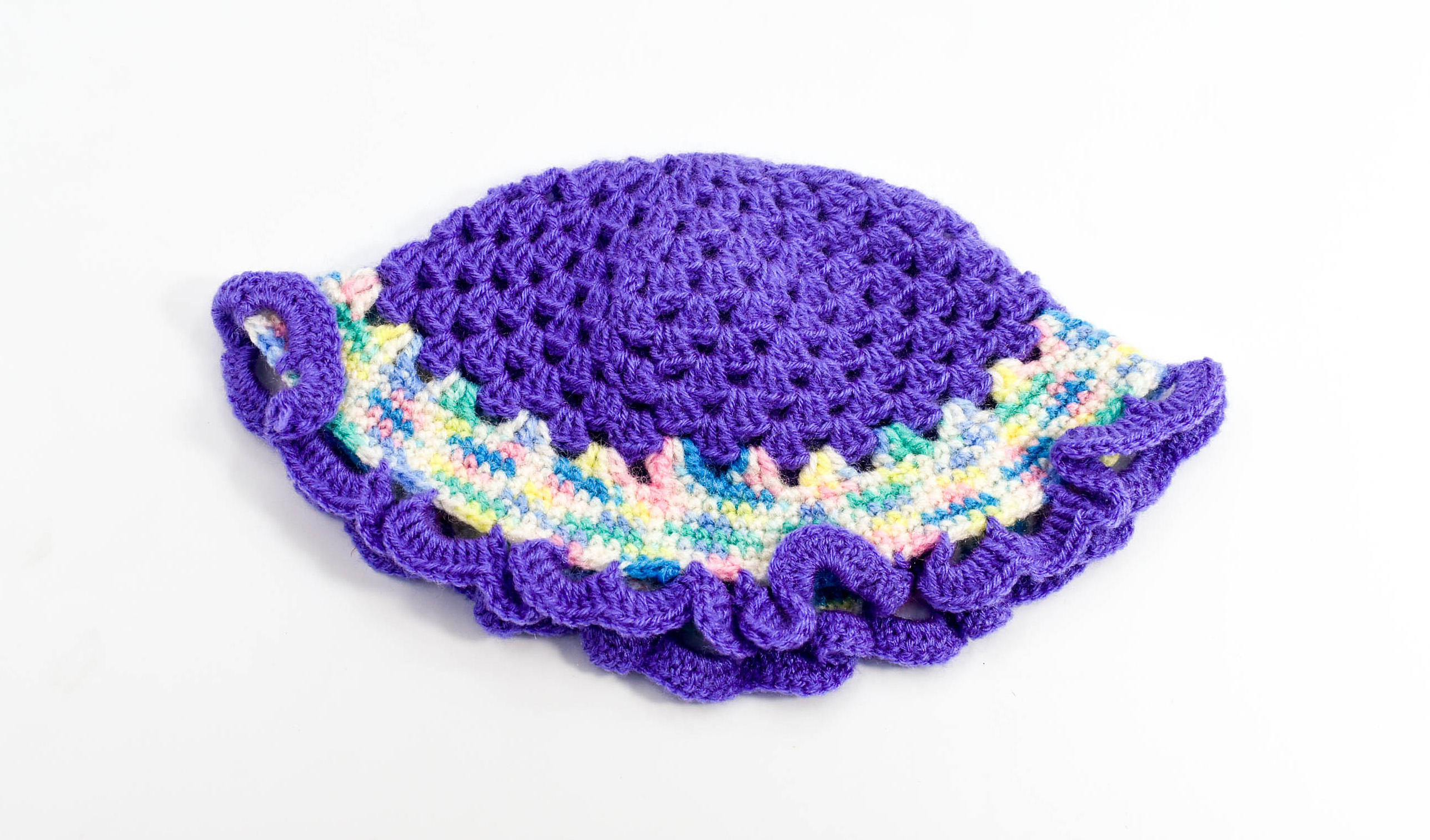 Handknitted multicolored woolen poncho with cap (0 months to 6 months) Handknitted multicolored woolen poncho with cap (0 months to 6 months)
